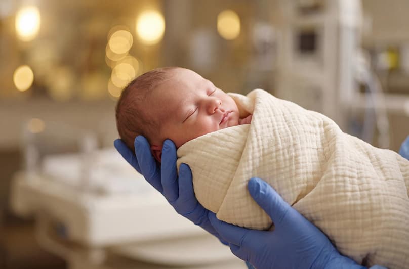 A baby sleeping soundly in a cot at home in Dubai