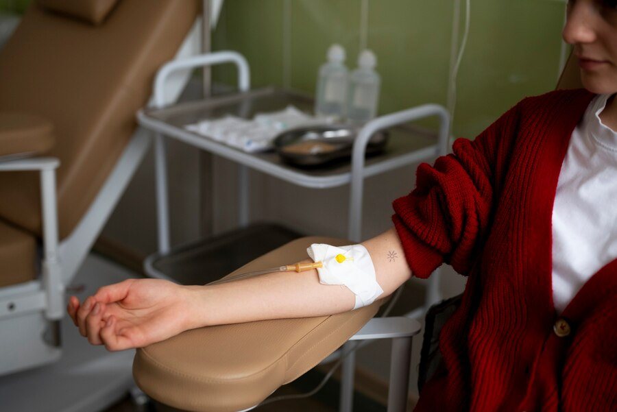A patient receiving an IV drip at home in Dubai