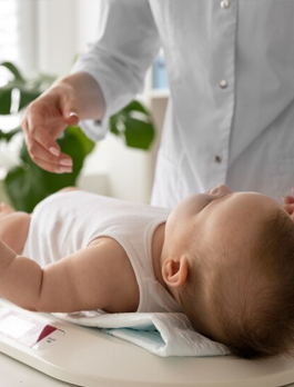 A Nightingale nurse giving a baby a massage at home in Dubai