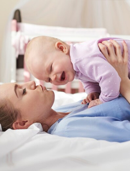 A baby sleeping soundly in a cot at home in Dubai
